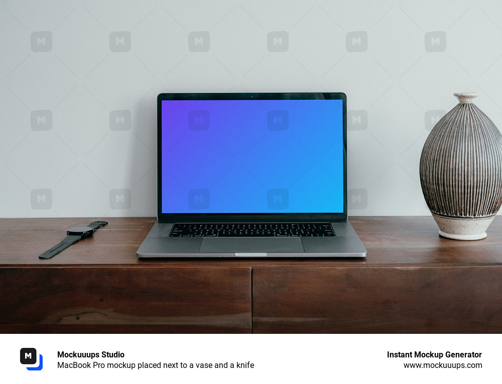 MacBook Pro mockup placed next to a vase and a knife