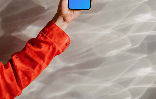 iPhone 13 Pro mockup held up against an ethereal background