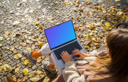 Woman working on a MacBook Pro 14 in autumn season mockup