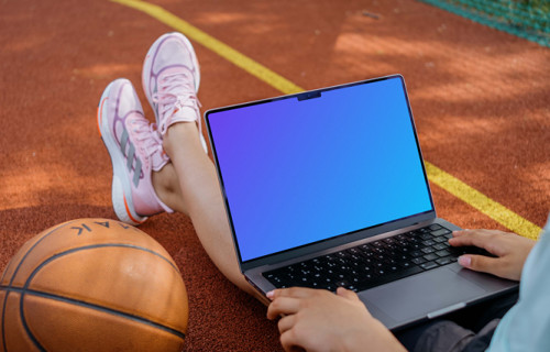 Basketball player checking on laptop mockup