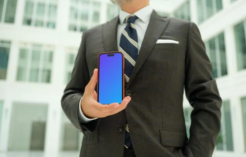 Businessman holding an iPhone mockup