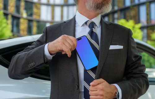 Businessman putting iPhone in his pocket