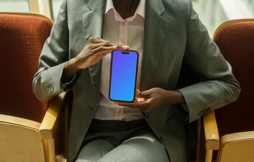Businesswoman holding an iPhone mockup