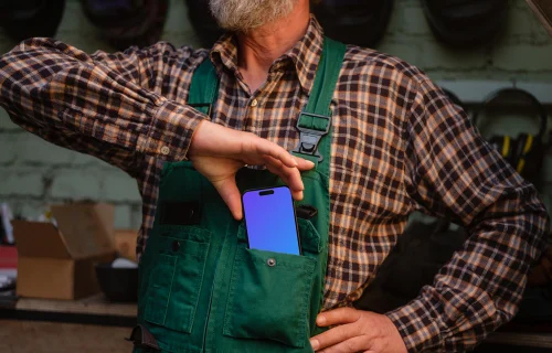Crafter pulling out iPhone 14 Pro of his pocket