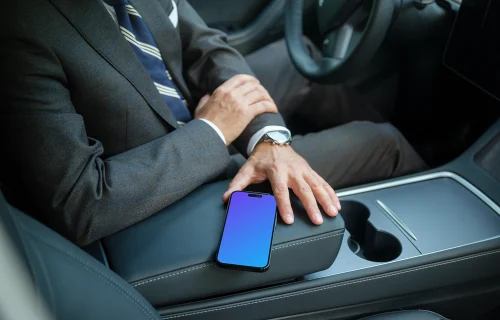 Entrepreneur sitting in Tesla with iPhone mockup