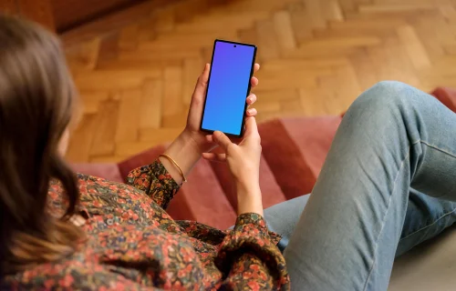 Female displaying Google Pixel mockup in wooden ambience of the lounge