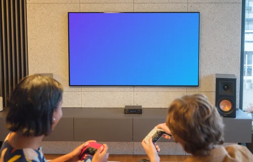 Gaming television mockup with players in modern living room