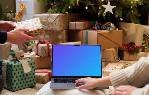 Laptop mockup surrounded by Christmas gifts