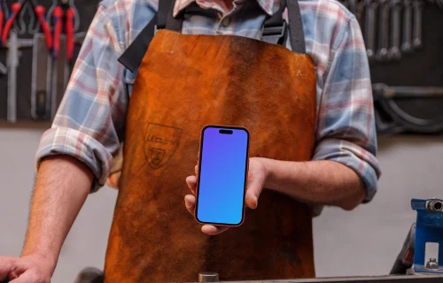 Leather crafter holding an iPhone mockup