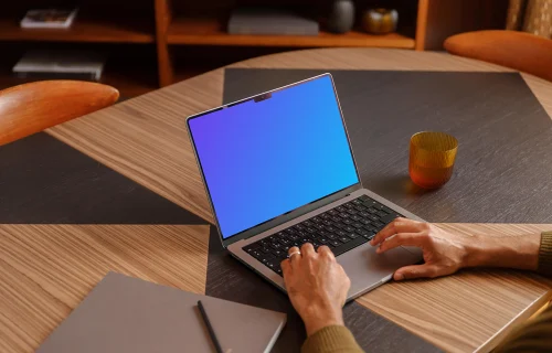 Office environment and man typing on a laptop mockup