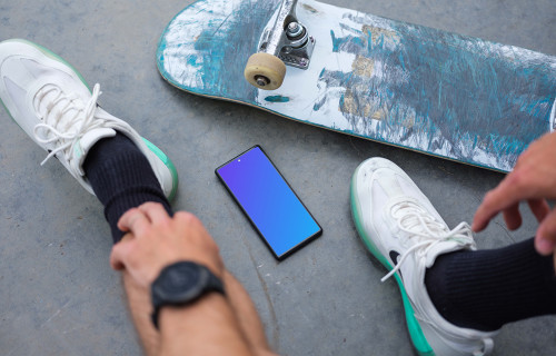 Skateboarder sitting next to a Google Pixel 6 mockup