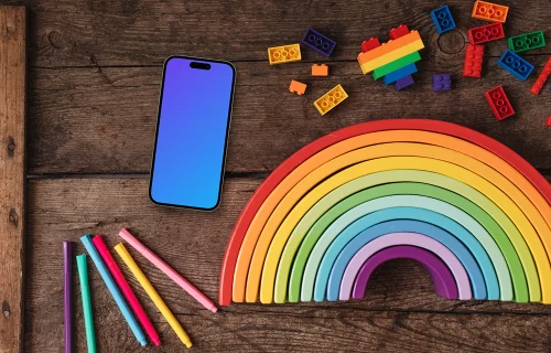 Smartphone mockup on a wooden table with rainbow items