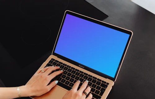 Woman typing a MacBook Air mockup