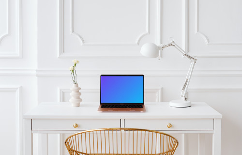 MacBook Air mockup on a table with a plant vase at the side