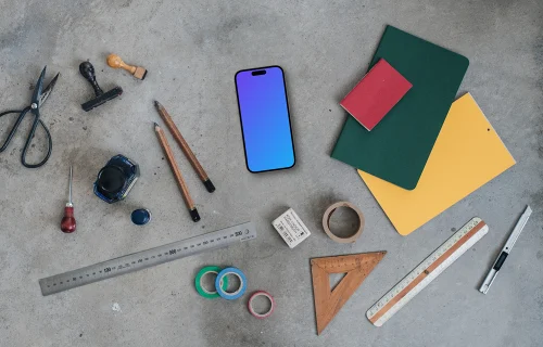 Smartphone mockup next to the colorful notebooks