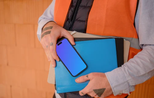 Construction worker presenting an iPhone 15 Pro mockup