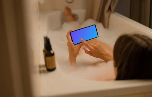 Female in bath typing on a Google Pixel mockup
