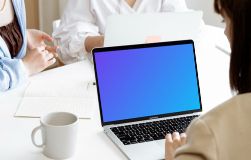 Female using a MacBook Pro mockup in a meeting
