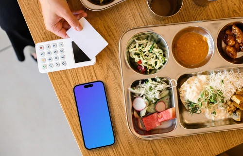 Food plate next to the iPhone mockup and payment terminal