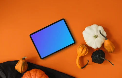 Halloween background mockup with tablet and pumpkins