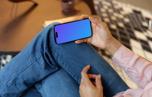 Hand holding an iPhone 14 Pro mockup