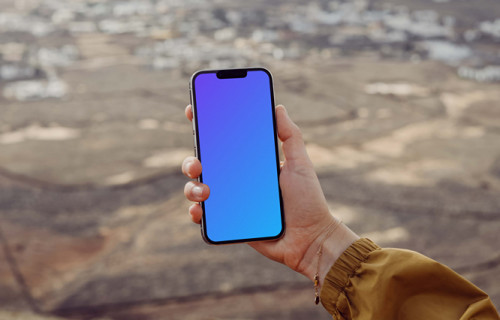  iPhone 13 Pro mockup held by a user from a high location.