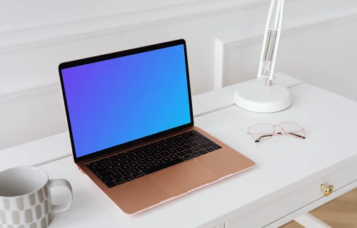 MacBook Air mockup on a table with a coffee mug at the side