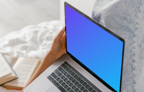 MacBook Air mockup used in bed by a lady