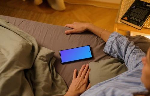 Woman laying in bed next to the Google Pixel 6 mockup