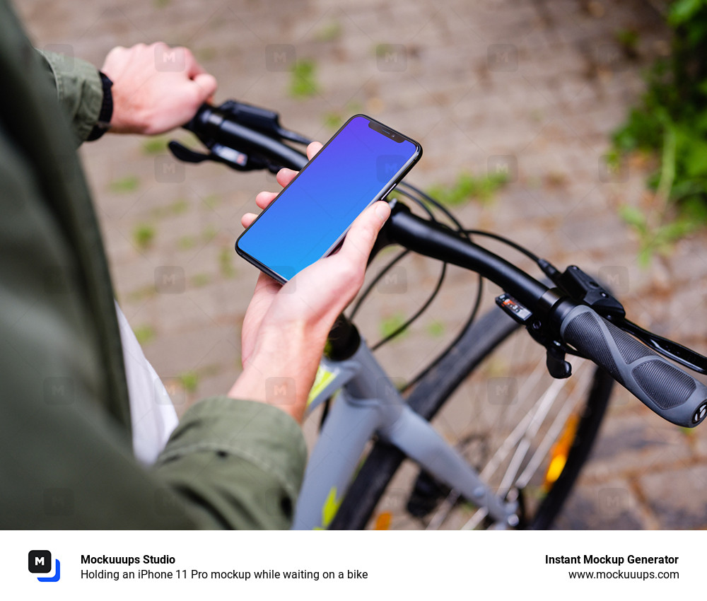 Holding an iPhone 11 Pro mockup while waiting on a bike
