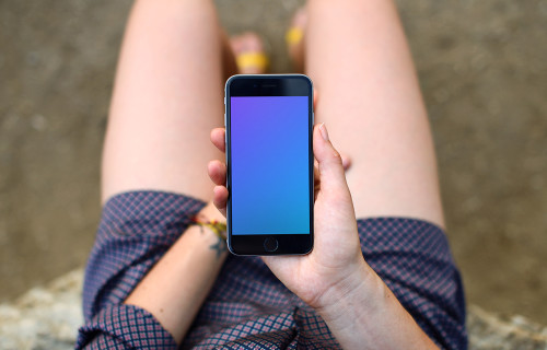 Woman in shorts looking on iPhone 6s mockup