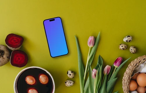 Coloring Easter eggs next to tulips and smartphone mockup