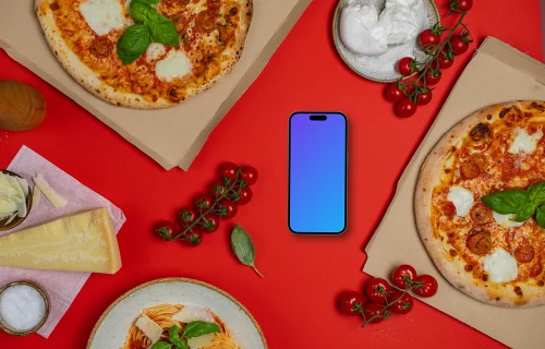 Phone mockup between pizza boxes 