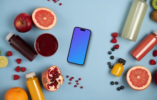 Smartphone mockup surrounded by fruits and juices