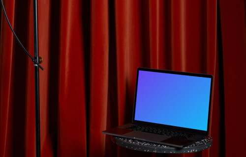 MacBook mockup en un taburete negro con una lámpara alta colgando encima
