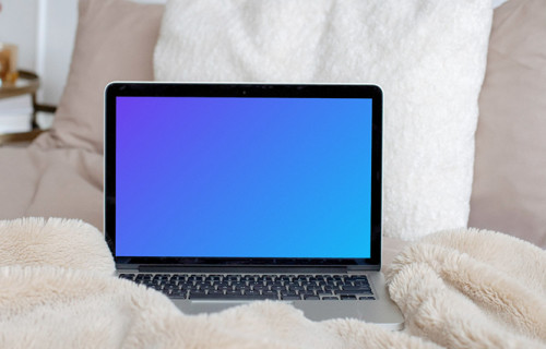 MacBook mockup en una cama de color crema con almohadas blancas de fondo