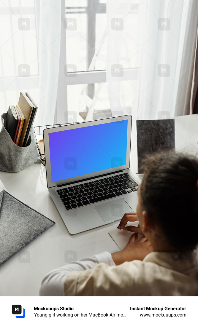 Young girl working on her MacBook Air mockup