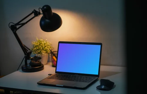 MacBook Pro mockup on a table with reading light